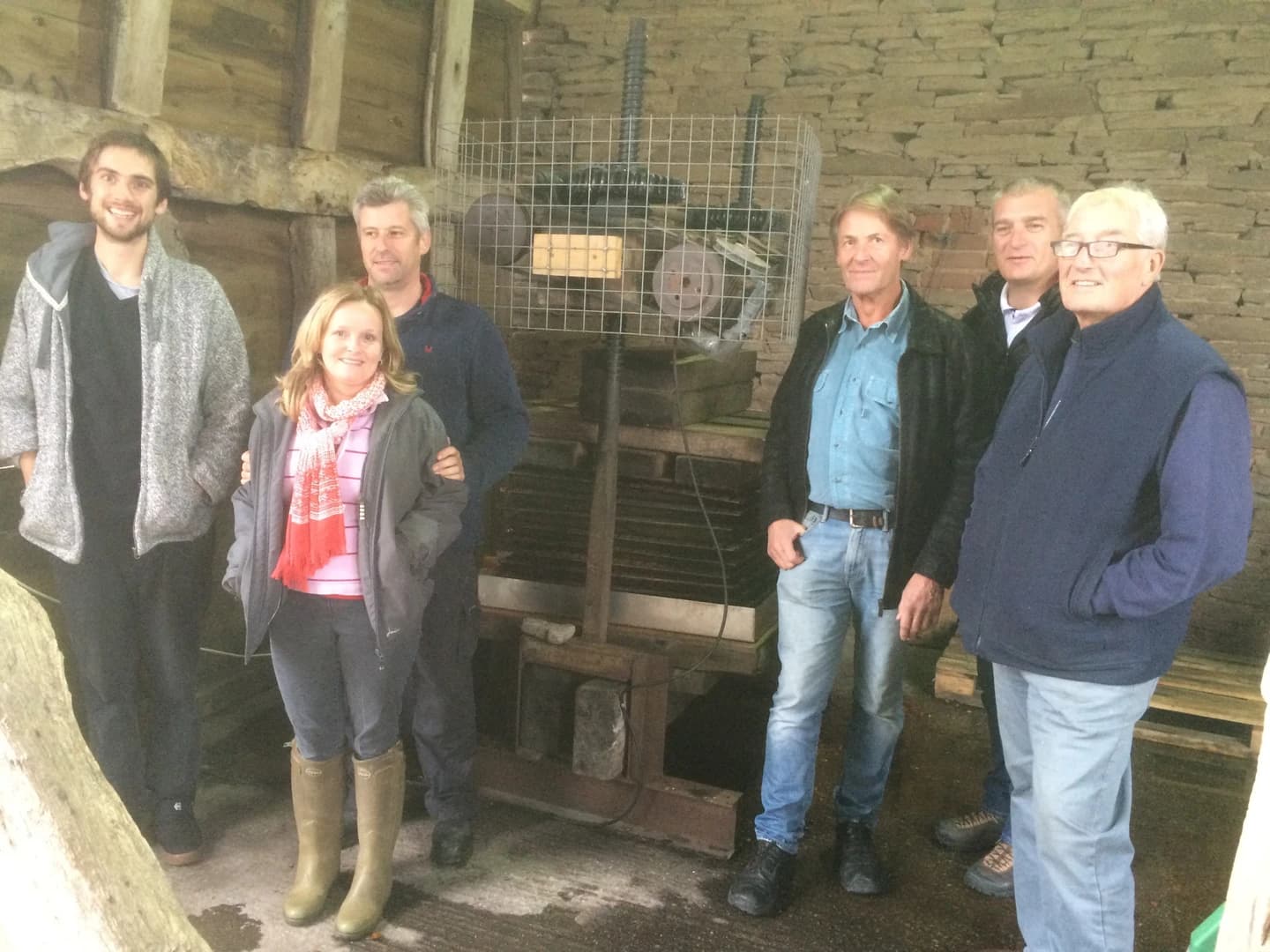 Course participants by the cider press learning the process
